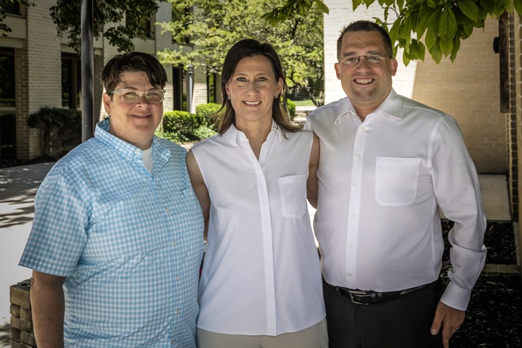 3 professionals taking a photograph together